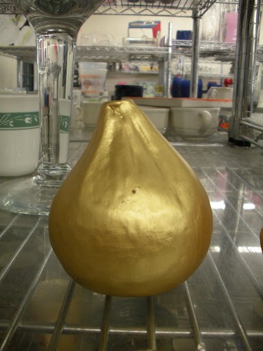 A gilded salt and pepper shaker.
