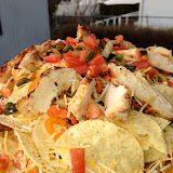A generous helping of leftover chicken, tomatoes, and cheese make the perfect grilled nachos.
