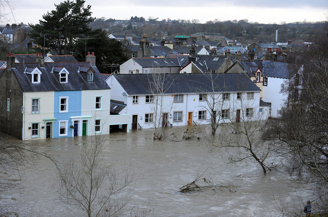 Flooded homes in Britain. Britain's coalition government will reduce spending on flood defense to about 2.1 billion pounds over the next four years, from 2.36 billion pounds over the last four years, according to the Department for Environment, Food and Rural Affairs. Andrew Yates / AFP / Getty Images