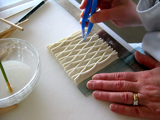 Step 7: And she does the same between the middle and the bottom.