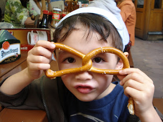 Eidan with a pretzel at a pub in Prague