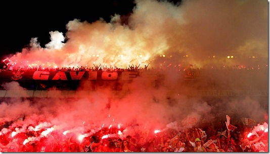 Fans of the Gavioes da Fiel samba school light flares during its parade in Sao Paulo. (Andre Penner/Associated Press)