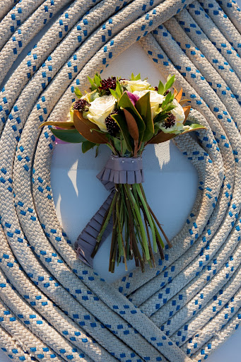 Chocolate cosmos and roses took center stage in the bridal bouquet, made by bridesmaid Leah Kefalos, and Chesnee Klein. Chocolate cosmos and roses took center stage in the bridal bouquet, made by bridesmaid Leah Kefalos, and Chesnee Klein.