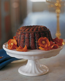 A steamed persimmon pudding is garnished with oven-dried persimmon slices A steamed persimmon pudding is garnished with oven-dried persimmon slices