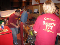 Students and engineering fixing the robot