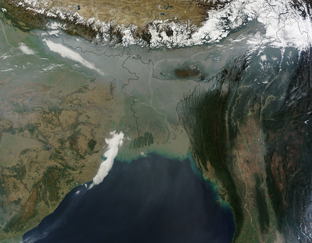 Lingering haze over south central Asia in late January, 2011, shrouding the lowlands south of the Himalayas with a gray veil. Between October and March each year, when rains are scarce and temperatures drop, the use of sulfur-rich coal, firewood and even used automobile and rickshaw tires are used to warm residents of the region. In addition, there are 5,000 registered brick kilns in Bangladesh alone, almost all of which burn coal and firewood. Jeff Schmaltz, MODIS Land Rapid Response Team, NASA GSFC