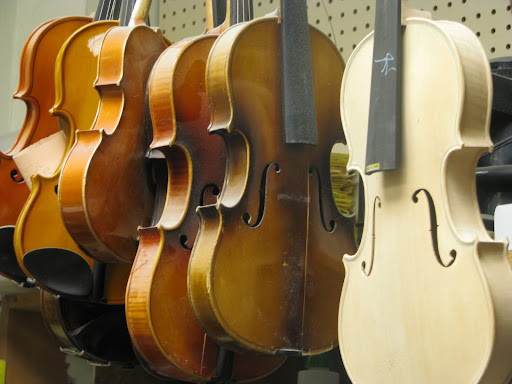 Violins and violas in the repair shop at Hoover Music. (Photo credit: Rebekah Clark)