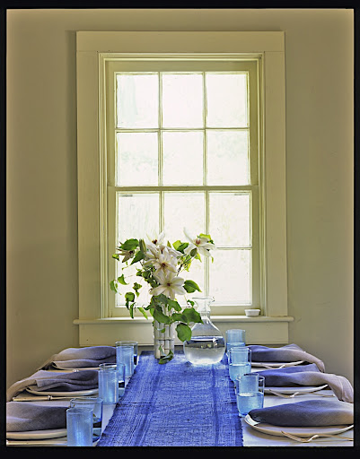 The table linens and glassware bring blue into this dining room nicely.
