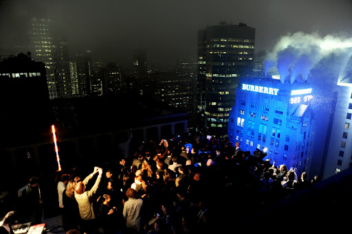 Guests on a rooftop across the street take in the spectacle. Guests on a rooftop across the street take in the spectacle.