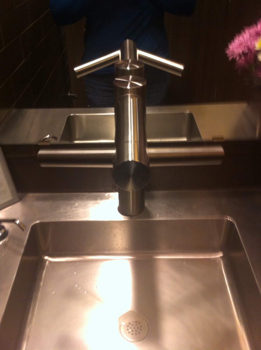 Love this faucet. The water comes from the middle and the side "wings" are ait hand driers