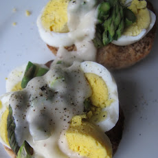 Chopped Eggs on English Muffins with Asparagus and Cheese Sauce