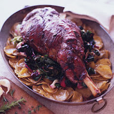 Roast Leg of Lamb on a Bed of Potatoes and Wilted Greens