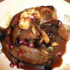 Pork Chop with Figs, Dates, Apples and Garlic in an Apple Cider Reduction Sauce