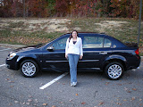 Katie being so excited standing next to her new car.