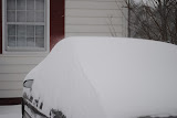 Another shot of the amount of snow on a vehicle.
