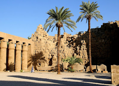 A man walks alone through Karnak Temple in Luxor, Egypt