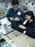 Loke and LK discuss a laser sub-assembly process. Loke and LK discuss a laser sub-assembly process.