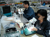 Loke and LK inspect receive diodes during the adhesive process development. Loke and LK inspect receive diodes during the adhesive process development.
