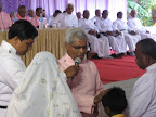 Bishop Dr.C.V.Mathew praying for the child of Rev.Lazar