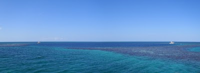 Panorama shot of the blue hole - the boat on the left is at the point we went in, in the foreground of the left boat is the entry/exit point Jacques Causteau(?) created with a pile of dynamite so his boat could get into the blue hole for filming a documentary back in the 70's. The boat on the right is the natural entry/exit point. bluehole2_1.jpg