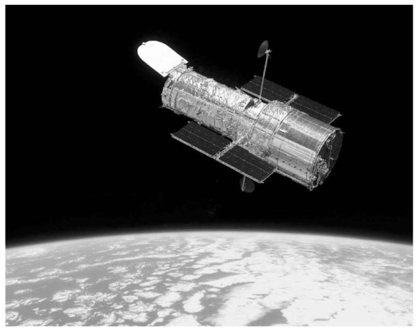 The Hubble Space Telescope, newly refurbished after Servicing Mission 3B in March 2002, orbits approximately 550 km above the surface of Earth. This figure is available in full color at http://www.mrw.interscience.wiley.com/esst.