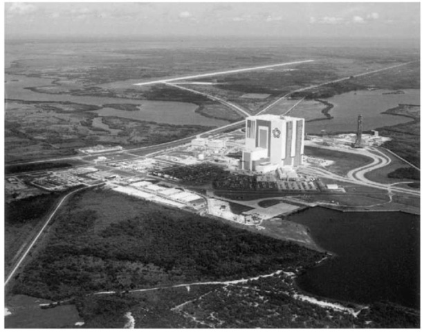 The Shuttle Landing Facility at the top of this 1983 photograph taken from the southeast. The VAB is prominent in the center, and the Launch Control Center can be seen nearer the bottom of the picture. The Orbiter Processing Facility is visible to the west of the VAB. The Mate/Demate Device is barely visible at the right of the apron between the SLF and the tow way to the OPF. The VAB displays the American flag and the U.S. Bicentennial symbol as a carryover of the Bicentennial ''Third Century America'' exposition held at KSC in 1976. The Bicentennial symbol has since been replaced by the traditional NASA ''meatball'' (NASA photo). This figure is available in full color at http:// www.mrw.interscience.wiley.com/esst.