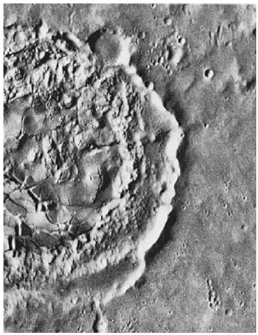  Fine detail in the interior of a martian crater can be seen in this photo taken by Viking 1 of an area near the Viking 2 landing site. The crater (on the left margin of the view) is about 40 kilometers (25 miles) in diameter and shows many features found in lunar craters. The central portion is crossed by numerous cracks. Similar features are seen at the huge lunar impact basin, Orientale. Their origin is unknown, but it has been suggested that the cracks were formed either by consolidation of lava that filled the crater after it formed, or by fallback from the impact process. Alternatively, the cracks may have formed long after the impact event by uplift of the crater floor. Between the cracked terrain and the crater rim is a region of chaotic debris. Beyond the rim there is no evidence of an ejecta blanket (rock material which is blasted from the crater by the shock of the impacting meteorite). The ejecta blanket is presumably overcovered by later deposits. 