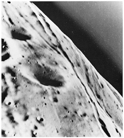 Viking Orbiter 1 took this close-up picture of Phobos from a range of 120 kilometers (75 miles) on February 20,1977. This is the closest range at which a spacecraft has photographed the tiny satellite. At that range, Phobos is too large to be captured in a single frame. This picture covers an area 3 x 3.5 kilometers (1.86 x 2.17 miles). A single picture element is about 3 meters (7.5 feet) across. However, the high relative speed of Orbiter 1 and Phobos caused some image smear so that the smallest surface feature identifiable is between 10 and 15 meters (32 and 49 feet). The picture shows a region in the northern hemisphere of Phobos that has striations and is heavily cratered. The striations, which appear to be grooves rather than crater chains, are about 100 to 200 meters (328 to 656 feet) wide and tens of kilometers long. Craters range in size from 10 meters (32 feet) to 1.2 kilometers (0.75 mile) in diameter. The surface of Phobos appears similar to the highland regions of the earth's moon, which also is heavily cratered and an ancient terrain. The dark region above the limb of Phobos is an artifact of processing and does not indicate an atmosphere.