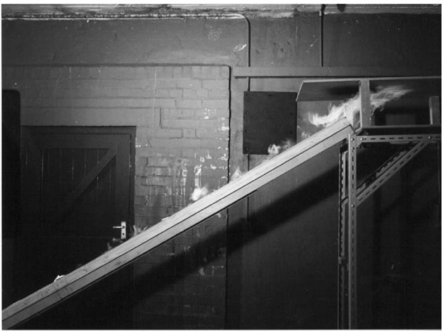 Fire tests on scale models of the escalator troughs at Kings Cross were conducted by the Health and Safety Executive at Buxton to demonstrate how the flames lay low in the trough with a jet of flame at the top - the 'trench effect'. Investigation into the Kings Cross Underground Fire, Desmond Fennell QC Cmm 499 HMSO London (1988). 