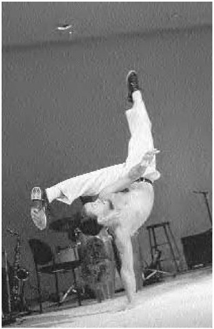 An acrobatic kick from a one-handed handstand, a signature move of capoeira, November 14, 1996.