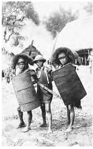 Warrior tribesmen of the Philippines with swords and woven shields, ca. 1900.