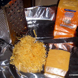 Shred large amounts of good cheddar cheese