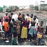  &ndash; Fr. Seraphim with children living in/near dump (James B. Mansaray, photographer)