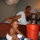  &ndash; Laurence "Roo" Mansaray playing with empty purchased water bottles. St. Laurence House purchased a few bottles of purified water to hold them over during the water shortage. Kadijah is in the background. June 2007 (James B. Mansaray, photographer)