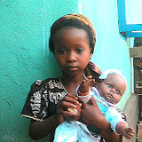  &ndash; Remember the little girl in the pink dress w hat, sunglasses? Her name is "Baby Rough" an indication of the kind of life she has had. A brand new doll was sent to her through Nazareth House Louisville. Here she is with it after James gave it to her. © NHA, J Mansaray 2007
