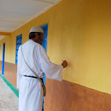  &ndash; Fr. Seraphim paints the NHA logo on the school building in Kabala to prepare for opening day. ...© 2008 September Nazareth House Apostolate Media, James B. Mansaray: photographer