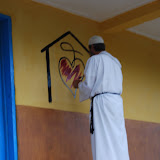  &ndash; Fr. Seraphim paints NHA Logo/Trade Mark on the Kabala School Building...© 2008 September Nazareth House Apostolate Media, James B. Mansaray, photographer.