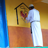  &ndash; Fr. Seraphim paints NHA Logo/Trade Mark on the Kabala School Building...© 2008 September Nazareth House Apostolate Media, James B. Mansaray, photographer.