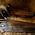 An Egyptian worker, seen by ancient Pharaonic sarcophagus inside a rock-cut tombs dating to the Middle Kingdom (ca. 2061-1786 BC) which has been discovered recently by an Egyptian archaeological mission sponsored by the Supreme Council of Antiquities (SCA) southeastern part of the pyramid field of Illahun, in Egypt's Fayoum region, Sunday April 26, 2009. (AP Photo/Amr Nabil)