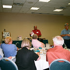 Owen auctions as George holds up Gleaves parking sign.