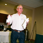 Allen Gleaves shows doll clothes  at the Auction.