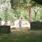 Click to Expand Virginia Melton rakes grass in Gleaves- Clements Cemetery, Hermitage, Tennessee