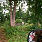 Click to Expand Virginia Melton picks up brush, Michael Gleaves Cemetery.