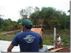 Joaquim, the construction guru, with Nicodemus putting up the roof panels.
