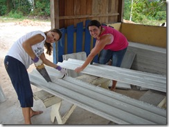 The Ladies cutting roof panels.