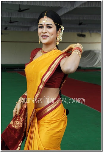 South Indian actress Shraddha Das in yellow Bridal saree with zari border