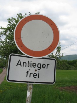 An+orange+triangle+sign+with+a+red+border+means