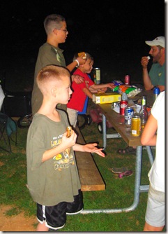 Everyone enjoying hotdogs and smores