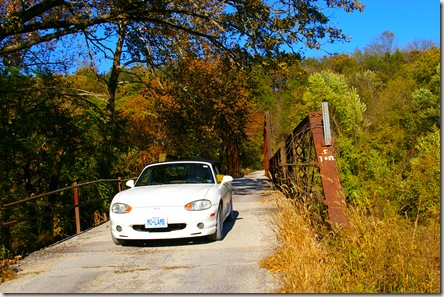 Jim driving his Miata across the old bridge