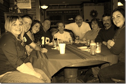 picture of family sitting around the table with tablecloth not quite covering the table